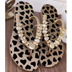 Golden slippers for women with black hearts decorated with stones and a golden accessory Golden slippers for women with black hearts decorated with stones and a golden accessory